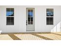 Classic front door with sidelight windows, set between two large picture windows at 1577 Periwinkle Dr, Mount Pleasant, SC 29466