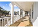 Expansive porch with white pillars and railing provides ample space for outdoor seating at 1577 Periwinkle Dr, Mount Pleasant, SC 29466