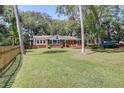 A charming brick home has a well-kept lawn and a relaxing front porch, ideal for enjoying the outdoors at 17 24Th Ave, Isle of Palms, SC 29451