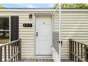 Close up of the white front door of a home with an open storm door and the house number above at 177 Cady Dr, Summerville, SC 29483