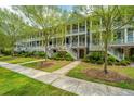 Attractive multi-story home with covered porches, healthy green lawn, and sidewalk at 2013 Grey Marsh Rd, Mount Pleasant, SC 29466