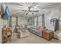 Comfortable living room with a large sectional sofa, modern ceiling fan, and plenty of natural light at 202 Oak Cir, Walterboro, SC 29488