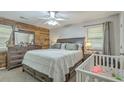 Relaxing main bedroom with rustic wood accent wall, neutral color scheme, and lots of natural light at 202 Oak Cir, Walterboro, SC 29488