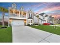 Lovely two-story home with balcony, an attached two-car garage, manicured lawn, and extended driveway at 204 Honey Horn Dr, Summerville, SC 29486