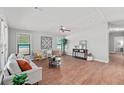 Cozy living room featuring comfortable seating, stylish decor, and natural light from windows with blinds at 208 Langham Ct, Moncks Corner, SC 29461