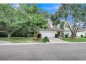 A charming, two-story home with a well-manicured lawn, a two car garage, and lush landscaping on a sunny day at 2136 Baldwin Park Dr, Mount Pleasant, SC 29466