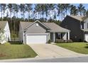 Inviting single-story home with a two-car garage and a well-maintained lawn in a quiet neighborhood at 222 Hayworth Rd, Summerville, SC 29486