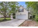 The side of this home features a pristine two-car garage and concrete driveway with room for multiple vehicles at 227 Lipman St, Summerville, SC 29483