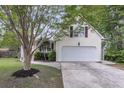 Side view of home with spacious two-car garage, clean driveway, and tidy landscaping at 227 Lipman St, Summerville, SC 29483