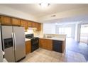 Kitchen featuring wood cabinets, stainless steel appliances, and an open floor plan at 2402 Riverridge Ct, Moncks Corner, SC 29461