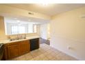 Open kitchen with stainless steel sink, wood cabinets, and view of the living area at 2402 Riverridge Ct, Moncks Corner, SC 29461