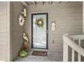 Welcoming front entrance with decorative wreaths, pineapple accent, and the unit number 2413 at 2413 Racquet Club Dr, Seabrook Island, SC 29455
