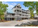 Attractive three-story condo features multiple balconies with metal roof and convenient parking at 2413 Racquet Club Dr, Seabrook Island, SC 29455