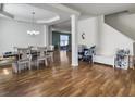 Open-concept dining area with hardwood floors, chandelier, and stairway access at 243 Donatella Dr, Goose Creek, SC 29445