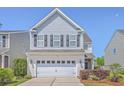 Two-story home featuring gray siding, a two-car garage, and attractive landscaping at 255 Longford Dr, Summerville, SC 29483