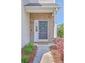 Inviting front entryway with a brick facade and a dark-colored door adorned with a decorative wreath at 255 Longford Dr, Summerville, SC 29483
