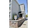 Side exterior showcasing the entrance with a caution sign: hidden driveway at 259 E. Bay St # 1A, Charleston, SC 29401