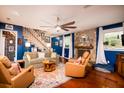 Inviting living room with a cozy fireplace, plush seating, and a large ceiling fan at 29 Meander Row, Charleston, SC 29412