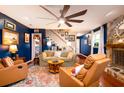 Inviting living room with a cozy fireplace, plush seating, and a large ceiling fan at 29 Meander Row, Charleston, SC 29412