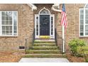 Close-up of front door, with address number 298, American flag, black door, and manicured front steps at 298 Hook Ln, Mount Pleasant, SC 29464