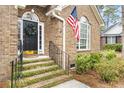 Close-up of front door, with address number 298, American flag, black door, and manicured front steps at 298 Hook Ln, Mount Pleasant, SC 29464