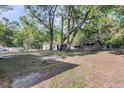 Large backyard area with mature trees and outbuildings at 3484 Johan Blvd, Johns Island, SC 29455