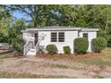 Charming cottage-style home with fresh white exterior and landscaping at 3484 Johan Blvd, Johns Island, SC 29455