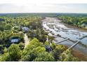 Aerial view of stunning waterfront home surrounded by lush landscaping and featuring private dock at 3600 Henrietta Hartford Rd, Mount Pleasant, SC 29466