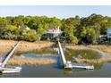 Beautiful waterfront home featuring a private dock, deck, and multiple levels of outdoor living space at 3600 Henrietta Hartford Rd, Mount Pleasant, SC 29466