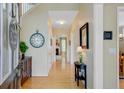 Bright foyer with hardwood floors, elegant decor, and a view of the staircase at 41 Regency Oaks Dr, Summerville, SC 29485
