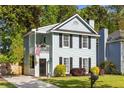 Charming two-story home with a light blue exterior, black shutters, and a cozy front porch at 540 Castle Hall Rd, Mount Pleasant, SC 29464