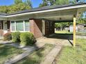 Charming single-story brick home with a covered carport and neat landscaping at 5458 Crown Ave, North Charleston, SC 29406