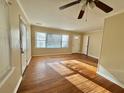 Bright living room with hardwood floors, a ceiling fan, and multiple windows at 5458 Crown Ave, North Charleston, SC 29406