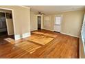 Spacious living room featuring hardwood floors and natural light from multiple windows at 5458 Crown Ave, North Charleston, SC 29406