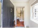 Inviting foyer with hardwood floors, white trim, and view of staircase at 55 Laurens St # 55-A, Charleston, SC 29401