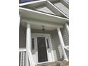 Close-up of the front porch featuring classic white columns and a stylish entrance, adding charm and elegance at 5691 Captain Kidd Rd, Hollywood, SC 29449
