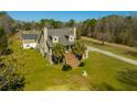Exterior of a charming home with two stories, a stone facade, manicured landscaping, and a welcoming entrance at 6440 St Anthony Dr, Hollywood, SC 29449
