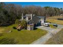 A well-maintained exterior of a multi-story home with stone base and landscaped front yard on a sunny day at 6440 St Anthony Dr, Hollywood, SC 29449