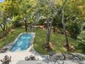 Aerial view of a backyard with a swimming pool, patio, and mature trees, offering privacy at 739 Wildwood Rd, Charleston, SC 29412