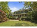 Charming two-story home with a covered front porch and well-manicured lawn and landscaped yard at 739 Wildwood Rd, Charleston, SC 29412