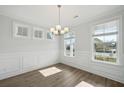 Bright dining room with decorative wall trim, light hardwood floors, and ample natural light from windows at 767 Maynard Ln, Summerville, SC 29486