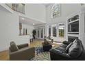 Bright living room boasting a fireplace, hardwood floors, large windows, and high ceilings at 79 Rivers Point, Charleston, SC 29412