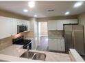 Modern kitchen featuring white cabinets, stainless steel appliances, and elegant granite countertops at 9471 Netted Charm Ct, Ladson, SC 29456