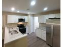 Bright kitchen with white cabinets, granite counters, stainless appliances, and modern fixtures at 9471 Netted Charm Ct, Ladson, SC 29456