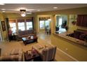 Open-concept living room with natural light, flowing into the kitchen and dining areas at 9677 Islesworth Way, Summerville, SC 29485