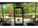 Inviting screened patio with outdoor furniture, offering serene views of the lush greenery at 9677 Islesworth Way, Summerville, SC 29485