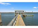 Dockside view with a walkway to a covered pier, providing serene waterfront access at 1214 Tabby Dr, Folly Beach, SC 29439