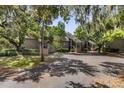 Exterior view of condo complex and parking lot with mature trees and Spanish moss at 108 High Hammock Villas Dr, Seabrook Island, SC 29455