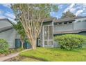 Exterior of a charming home with mature landscaping, lush lawn, and multiple large windows providing ample natural light at 1134 Shadow Lake Cir # 55, Mount Pleasant, SC 29464