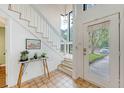 Bright foyer featuring tile floors, a staircase with rope detail, and access to outdoor spaces at 1134 Shadow Lake Cir # 55, Mount Pleasant, SC 29464